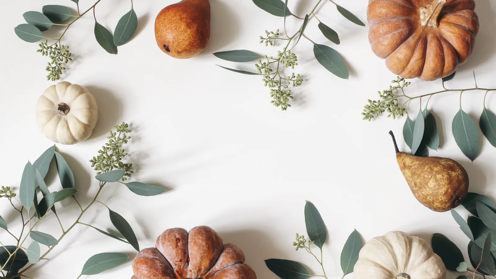 decorative pumpkins and leaves on a table