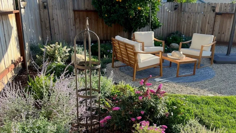Backyard sanctuary with shaded seating area and small lawn