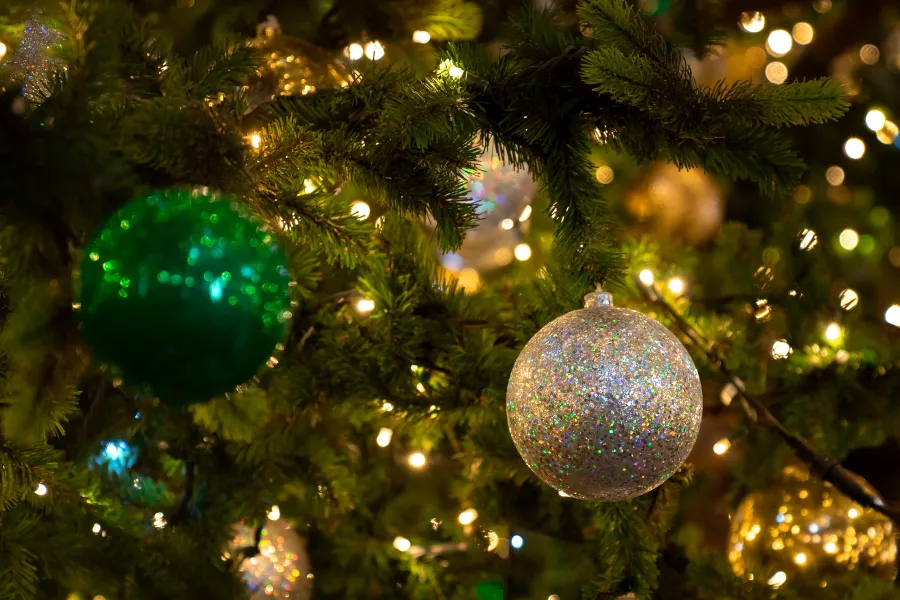 artificial christmas tree at night with lights and shiny christmas balls