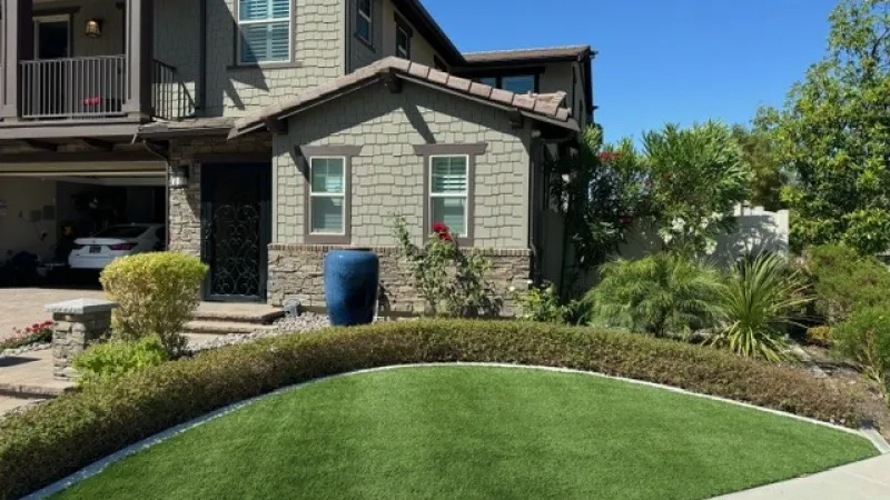 Front landscape redesign with water saving artificial turf and a formal boxwood hedge