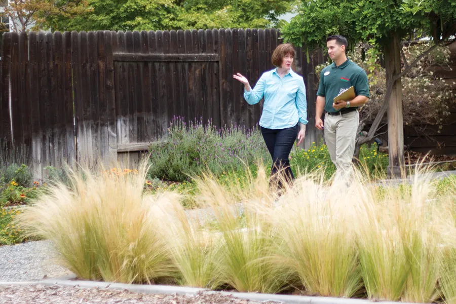 a man standing in front of a banana tree