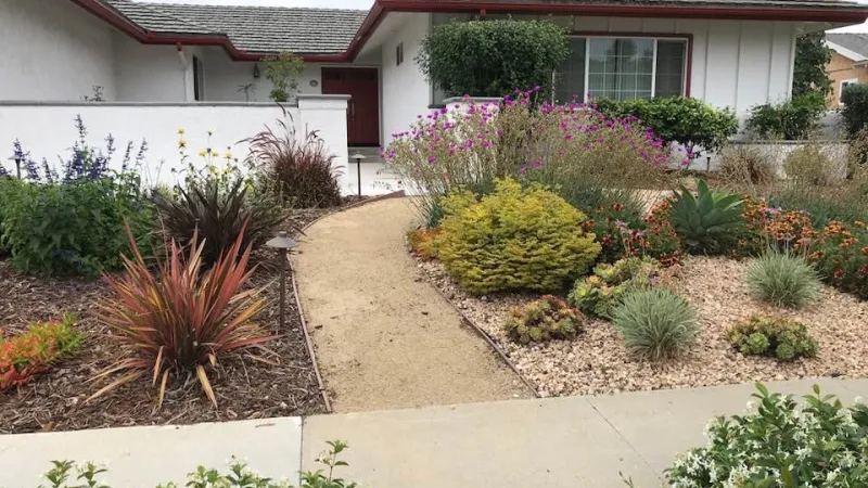 A lighted decomposed granite walkway guides you through this drought tolerant front garden in Thousand Oaks, California