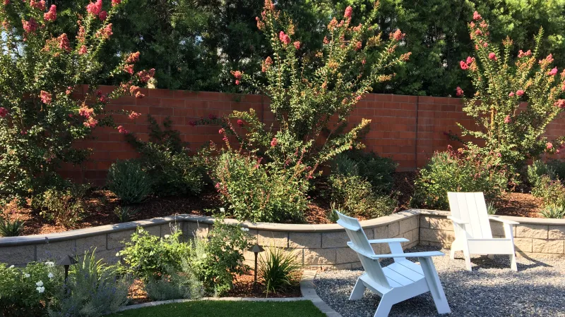 A pair of Adirondack chairs help create a backyard sanctuary