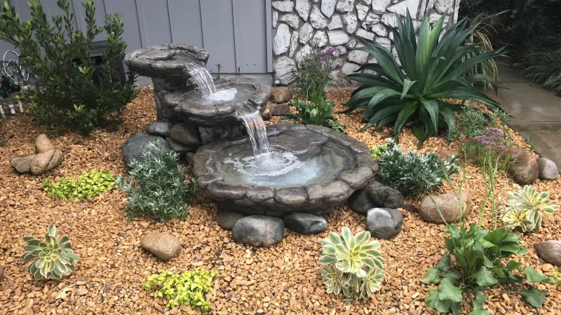 A peaceful fountain adds a nice touch to this entry garden
