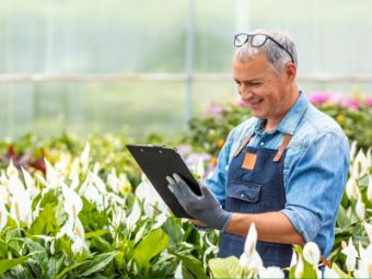 Man with a checklist surrounded by plants