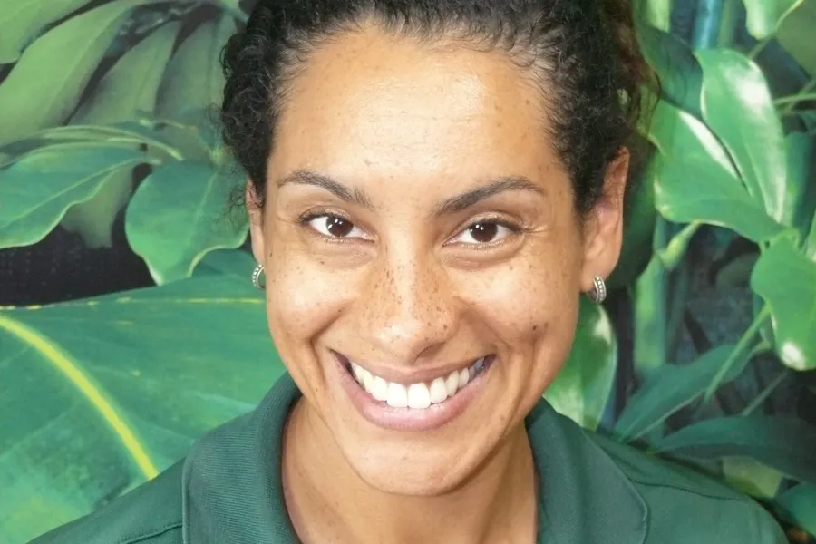a smiling person in a green shirt